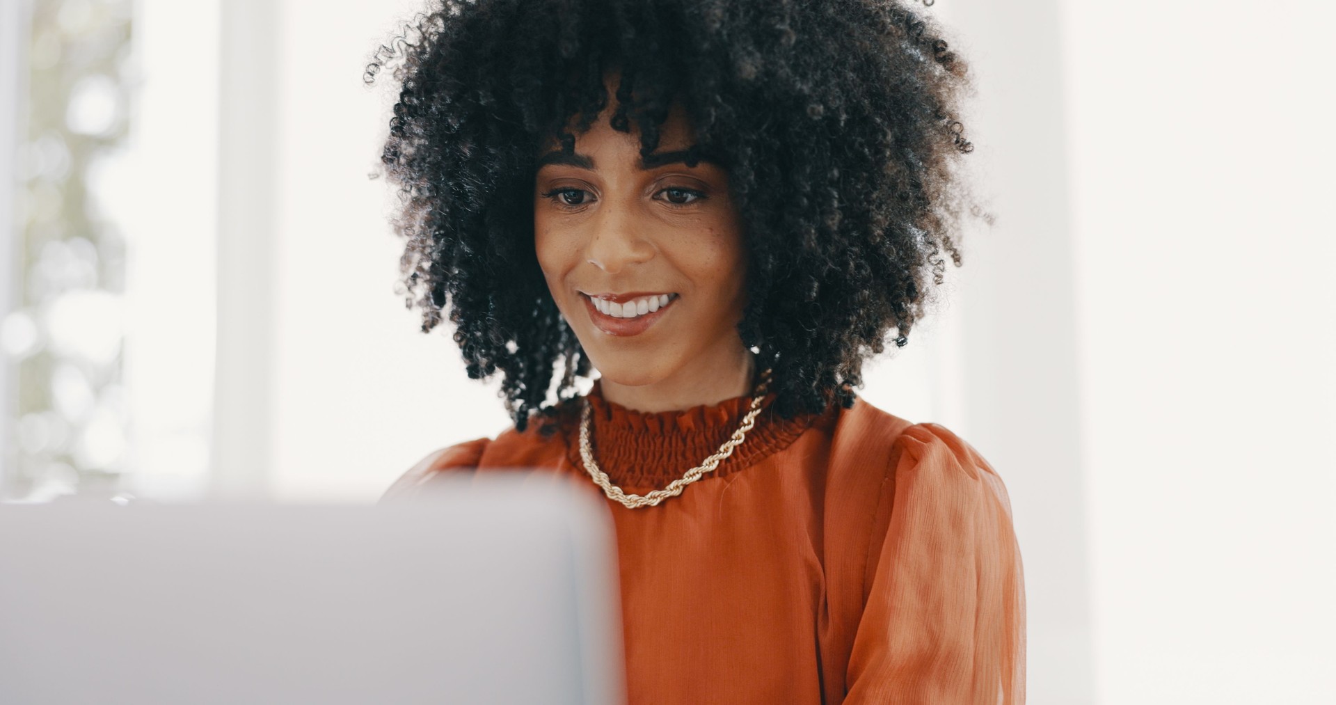 Happy, laptop and business black woman in office for typing email, website or digital marketing. Creative agency, professional analyst and worker on computer for internet, planning and online project